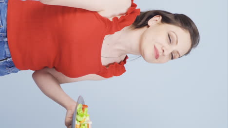 Vertical-video-of-A-person-who-diets-and-eats-healthily.-She-eats-salad-and-dances.
